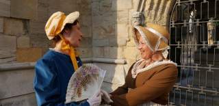 Two women dressed up as Jane Austen