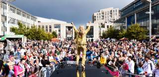 Southampton Pride mainstage with person in a gold suit and crowd