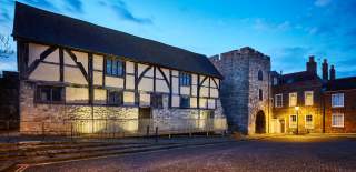 The historic Westgate Hall in Old Town lit up at dusk
