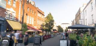 Street with restaurants either side and people walking