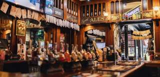 Front of traditional pub bar showing beer pumps