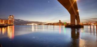 Under Itchen Bridge over water at night time