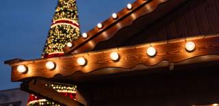 Closeup of Christmas Market Chalet rooftop with Christmas tree in background