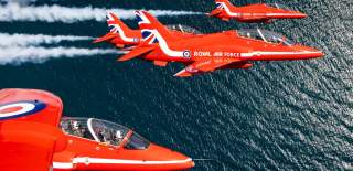 5 Red Arrows flying above open water