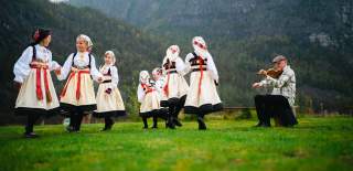 Jenter i bunad som danser gangar