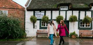 Two girls leave a pub in Wirral.