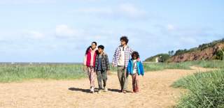 A family walk along the beach