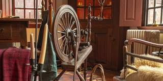 Rustic Interior With Cabinets, Chairs And Spinning Wheel At Stephen Hopkins House