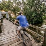 man biking over bridge in Hoyt Park