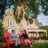 Couple drinking wine in front of a house