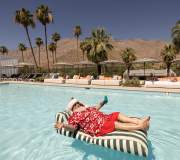 Santa on a floaty in a pool in Palm Springs for the holidays.