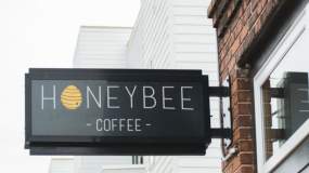 The business sign for the Honeybee Coffee Co features their name and a little honey bee.