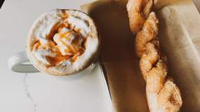 A cinnamon twist sits next to a sweet drink at The Golden Roast in Knoxville.