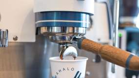 Fresh espresso from Mahalo Coffee Roasters is poured into a customer's drink.