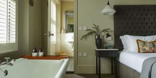 Bedroom with rolltop bath at The Swan in Wedmore