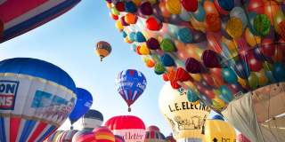 A group of balloons lifting off in a mass ascent at Bristol International Balloon Fiesta - credit Paul Box