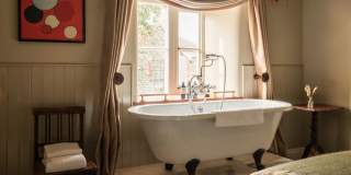 Rolltop bath in bedroom at The Manor House Inn