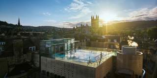 An aerial view of the rooftop pool at the Thermae Bath Spa in central Bath, with Bath's skyline in the background