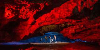 A family in a cave at Wookey Hole in Wells, near Bristol - credit Wookey Hole