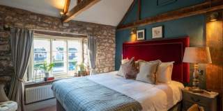 A large bed in a bedroom at The Bowl Inn - Credit The Bowl Inn