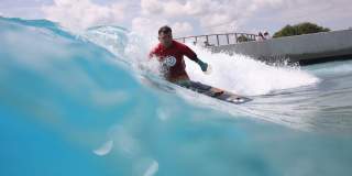 A surfer taking part in adaptive surfing at The Wave inland surfing lake near Bristol - credit The Wave