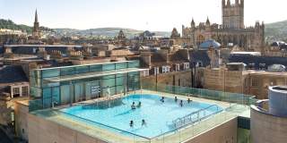 An aerial view of the rooftop pool at the Thermae Bath Spa in central Bath near Bristol, with Bath's skyline in the background