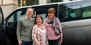 People stood in fron tof minivan - credit In and Beyond Bath