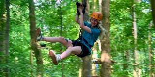 Person on zip line in tree tops - credit Adventure Bristol