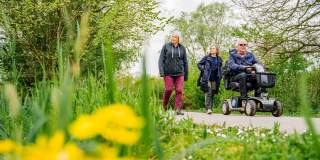A mobility scooter user on a trail with family at WWT Slimbridge Wetland Centre near Bristol - credit WWT Slimbridge Wetland Centre