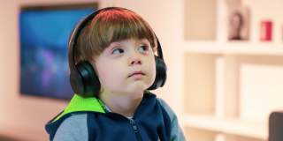 A young boy wearing headphones at the We The Curious science centre in Bristol - credit We The Curious
