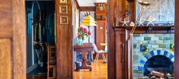 A beautifully decorated hallway can be seen, along with a glimpse of a living room in Cairn Bay Lodge