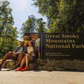 family in front of Smokies sign