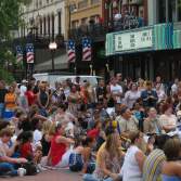 Crowd Of People Sitting In Front Of A Theatre
