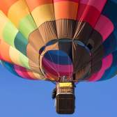 A multicoloured balloon in the sky over Bristol