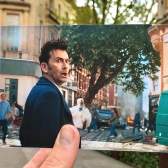 A view of Clare Street in Bristol's Old City, with a hand holding a photograph of actor David Tennant filming one of the 2023 Doctor Who specials in the same spot - credit Logan Walker