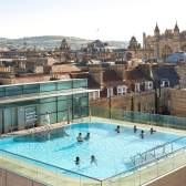 An aerial view of the rooftop pool at the Thermae Bath Spa in central Bath near Bristol, with Bath's skyline in the background