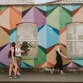 A tour guide leading a group past artworks painted during the Upfest street art festival in South Bristol