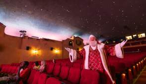 Santa standing by the seat at the Plaza Theatre in Palm Springs