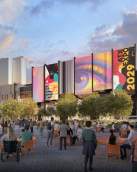 Austin Convention Center rendering shows the outdoor event space with attendees in the foreground looking towards a large screen showcasing ATX Expo 2029 signage on the north side of the building. The Fairmont hotel is in the background and the space includes trees and greenery in front of the building.