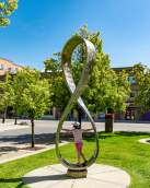 Child playing on public art at Kelowna Regional Library