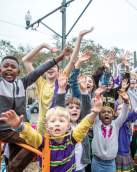 Kids Watching a Mardi Gras Parade Together