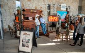 Outdoor, trade-show style exhibit set up for Allens Boots near a backdrop that says "South Austin."