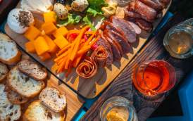 Table set with various meats, cheeses, and mead at Meadow Vista Honey Wines