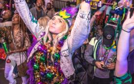 Woman with Hands in the Air at a Mardi Gras Parade