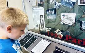 Track and Field HOF Museum boy looking at Olympic medals