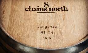 Oak barrel branded with the 8 Chains North Winery logo, marked for méthode traditionnelle sparkling wine aging in Loudoun