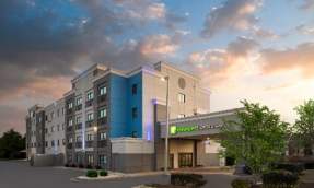 Exterior of Holiday Inn Express & Suites Leesburg with landscaping and parking area in Leesburg, Virginia.