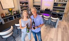 Bob and Loree Rupy, owners of October One winery, wine bottles in their Leesburg tasting room.