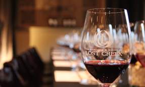 Glass of red wine etched with the Lost Creek Winery logo in the tasting room in Leesburg, Virginia