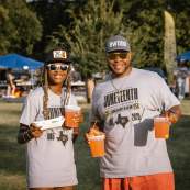 Photo of two people with drinks and food from vendors at the Fun in the Park event during the Juneteenth celebration.